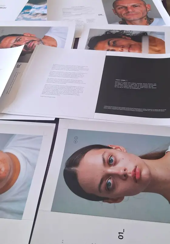 Printed portrait pages and text pages spread out on a table.