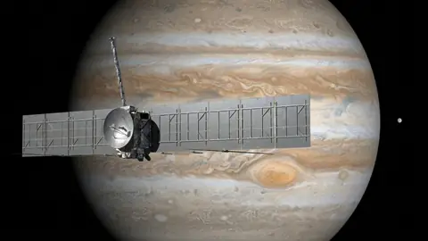 Seed 01: a probe with long grey panel wings in front of a banded gas giant with a red storm.