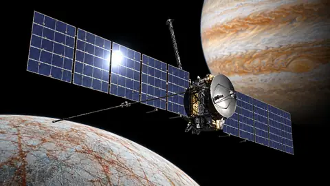 Seed 03: a probe with blue panel wings and a dish antenna, seen three-quarter, above the ice moon with the gas giant and a bright sun behind.